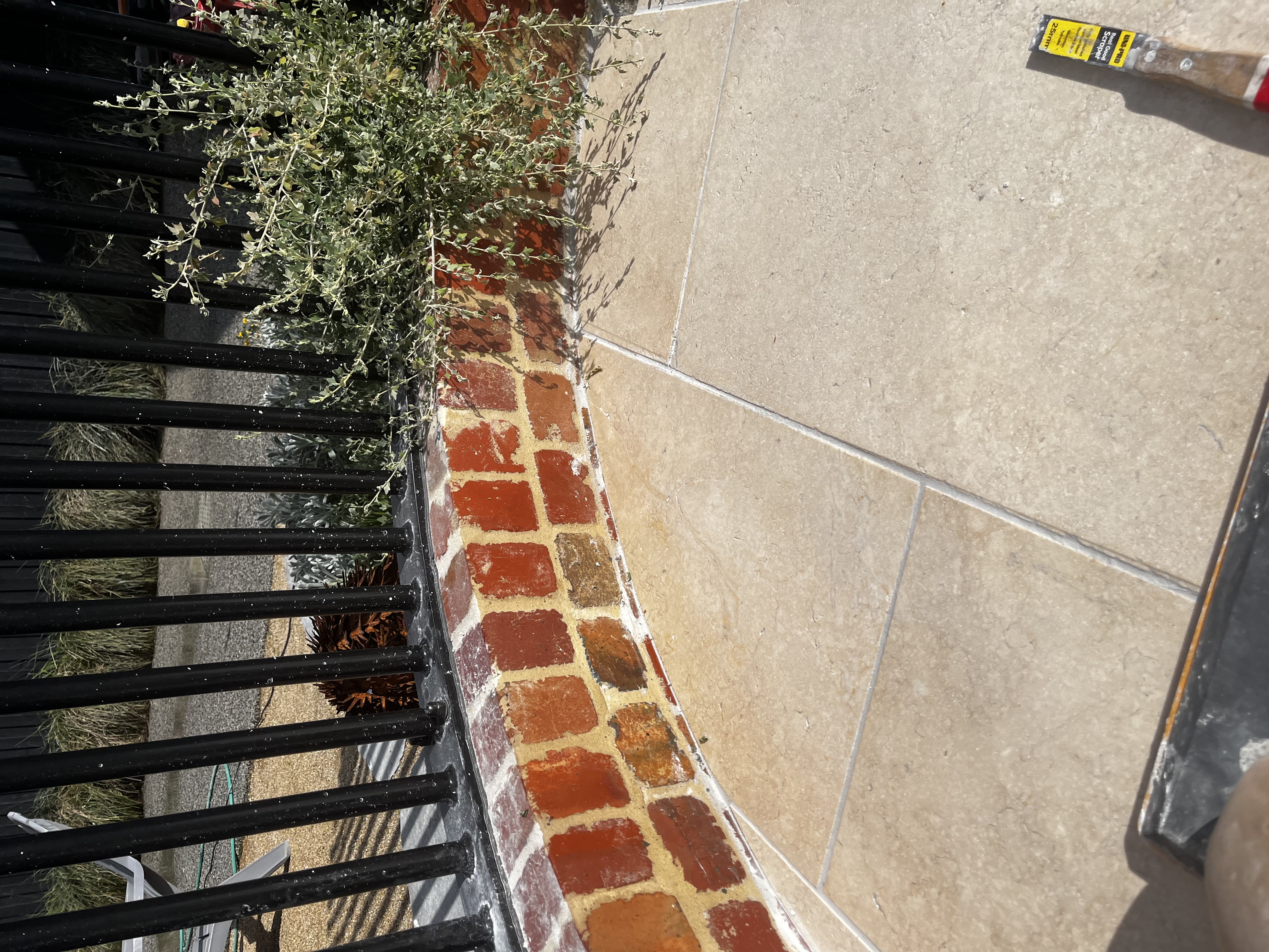 Completed concrete sleeper retaining wall and lawn on a South East Melbourne project