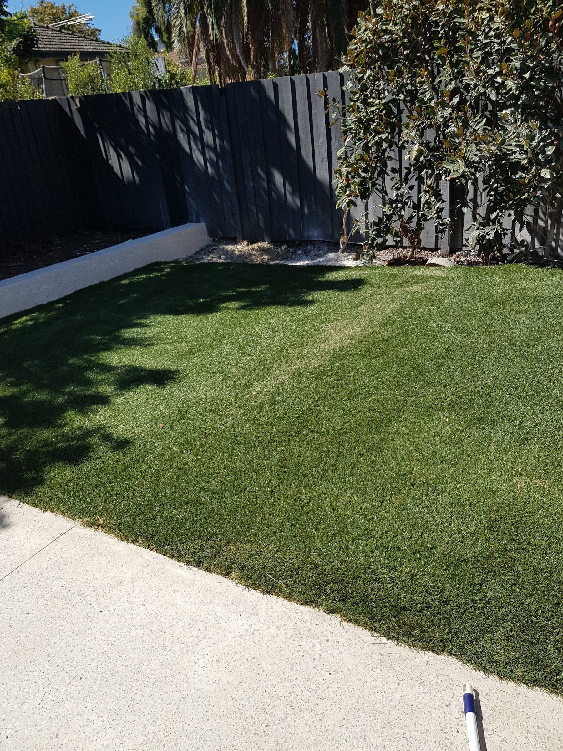 Synthetic lawn against a concrete path