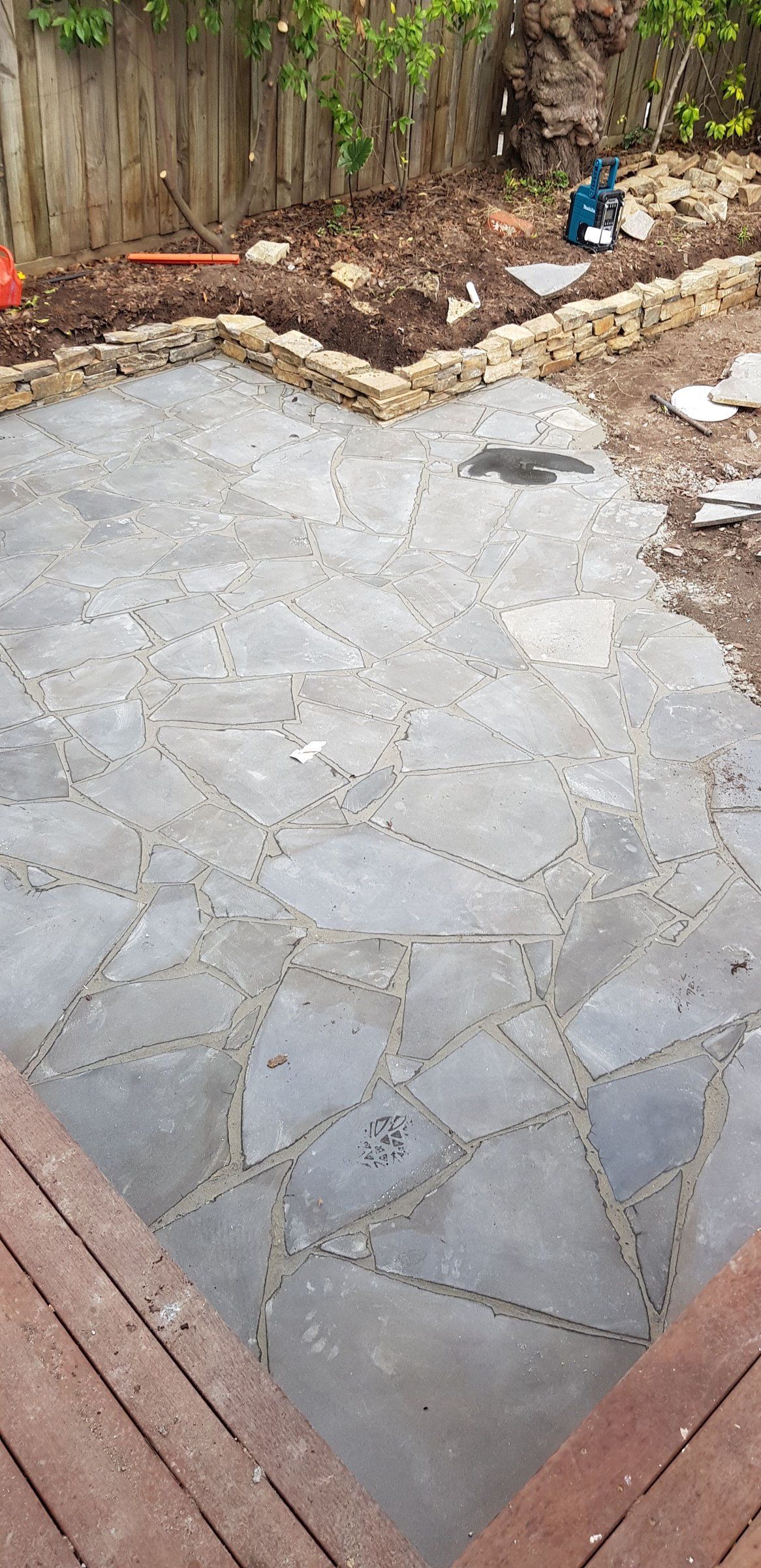 Crazy pave patio beside a timber deck