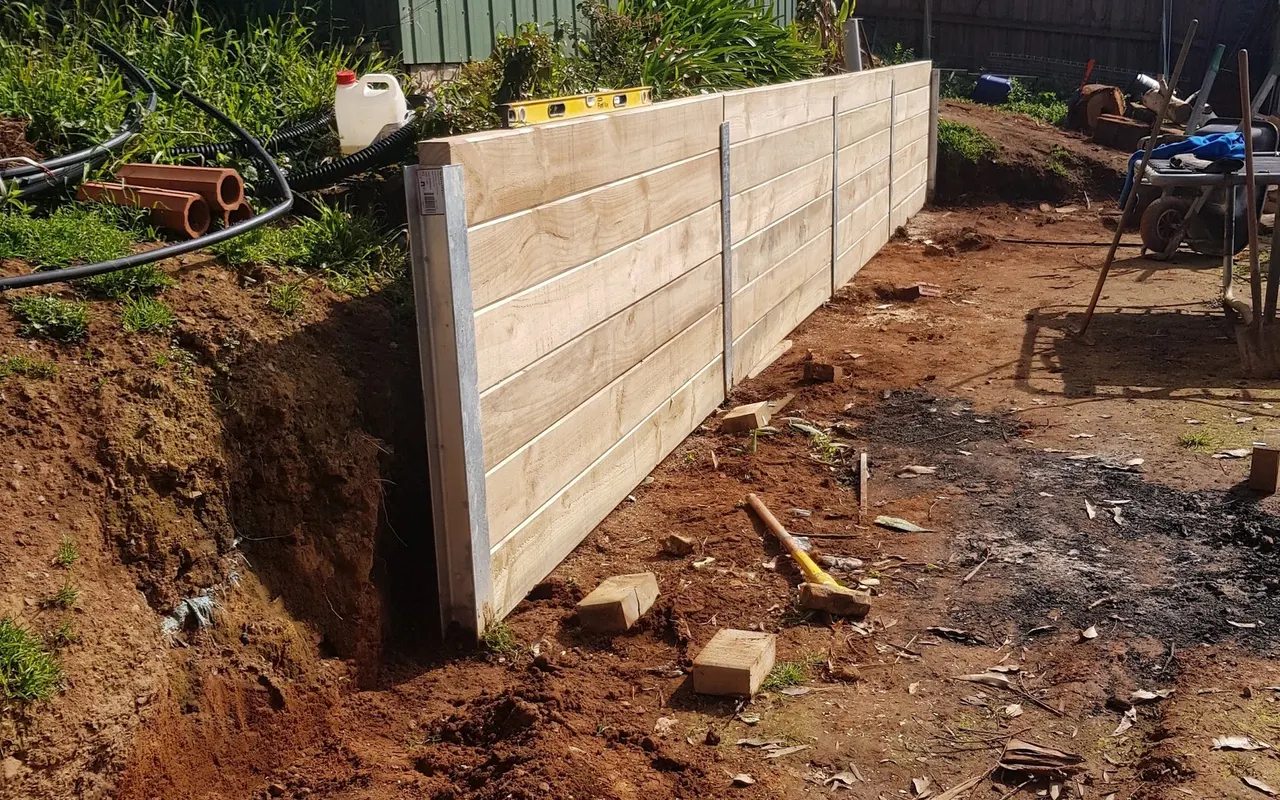 Timber sleeper wall on a cut beside the shed