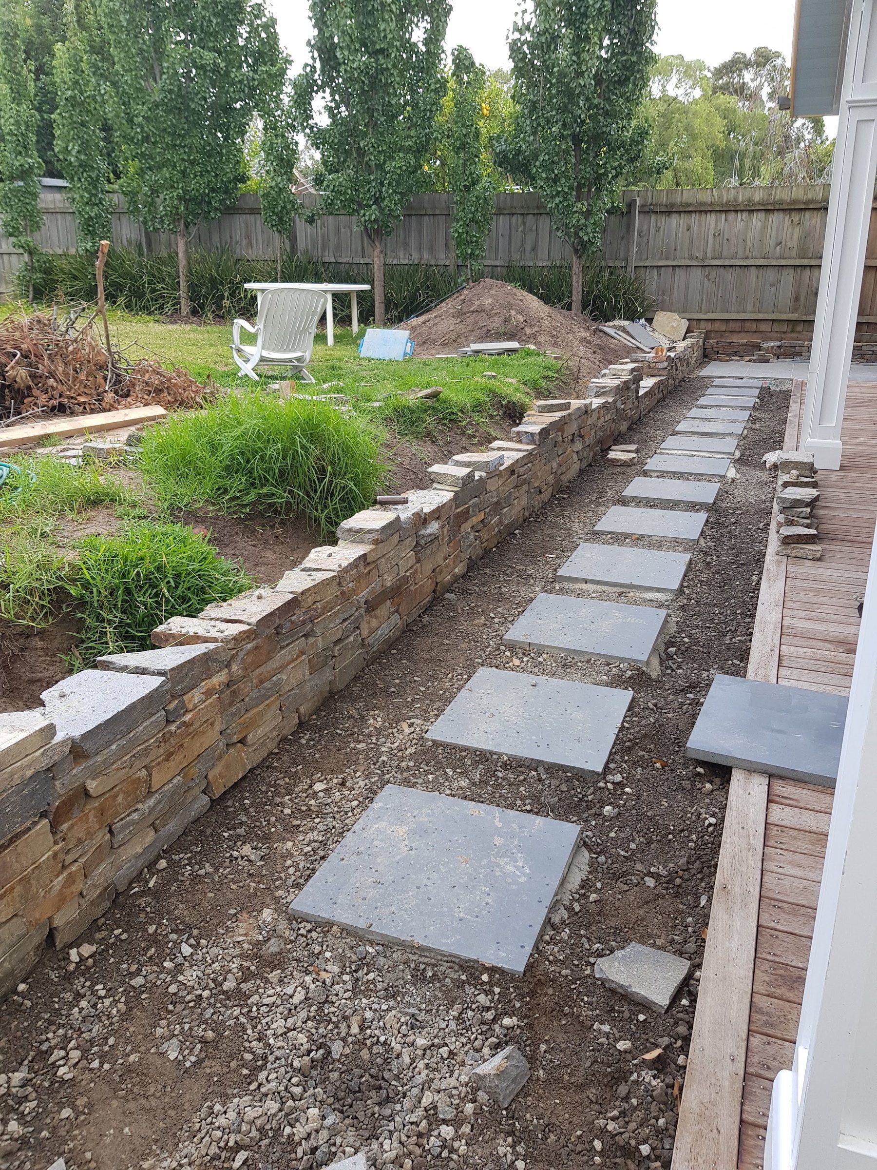 Stone retaining wall and stepping path