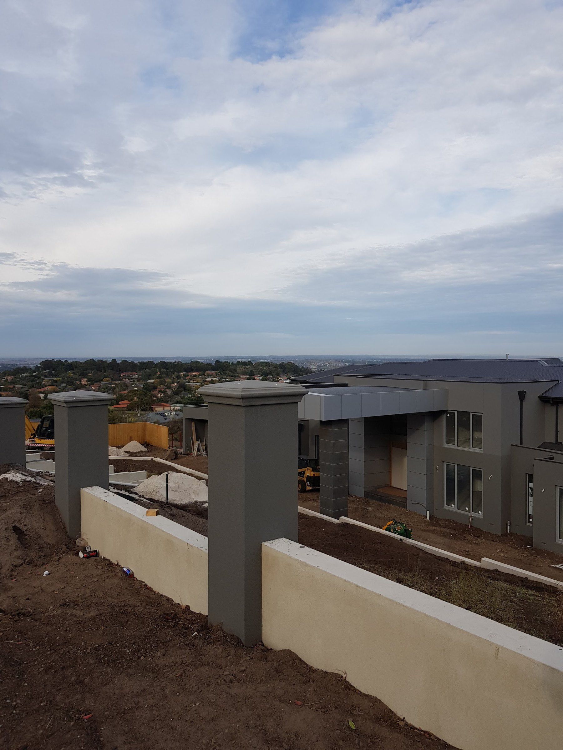Rendered boundary wall and entry piers, ground still open
