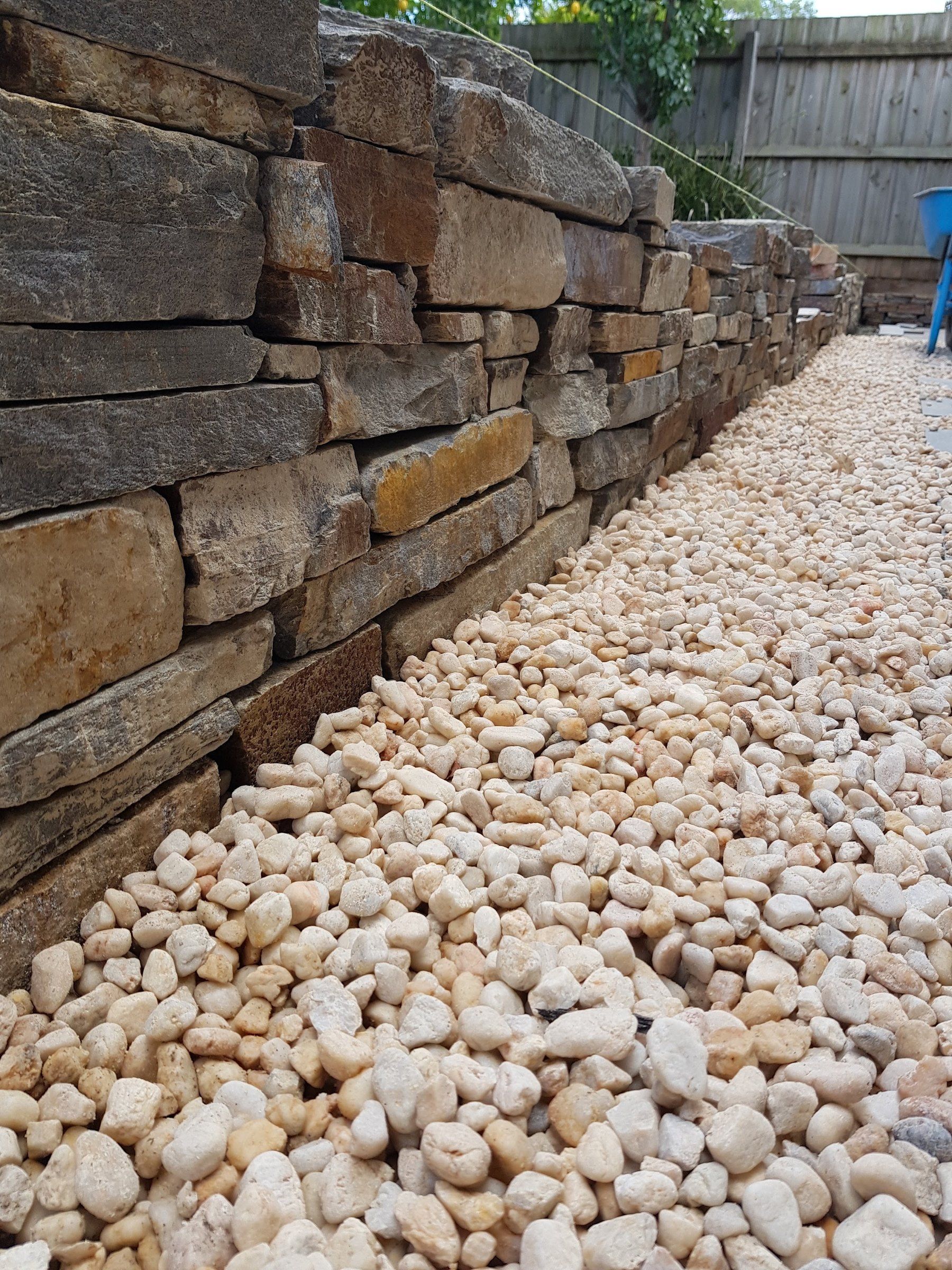 Pebbles against a dry stone wall